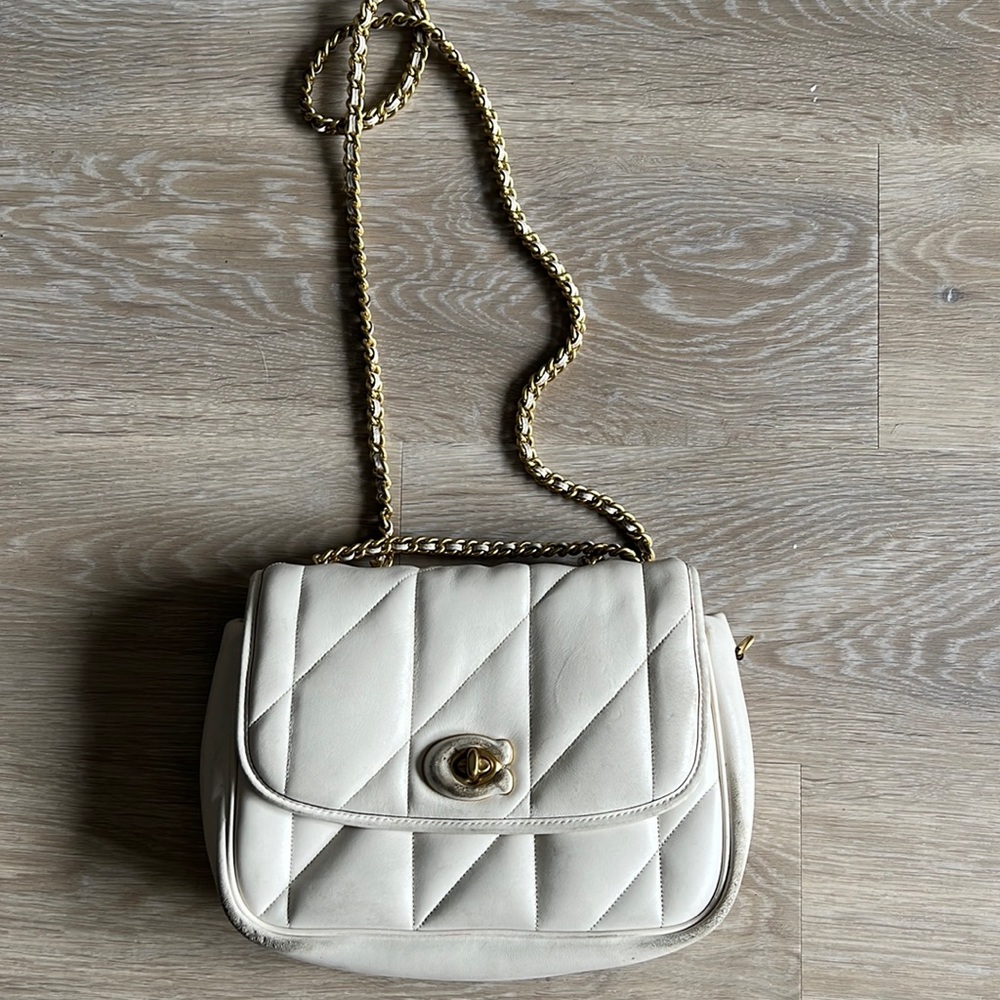 Cream crossbody Coach Bag.